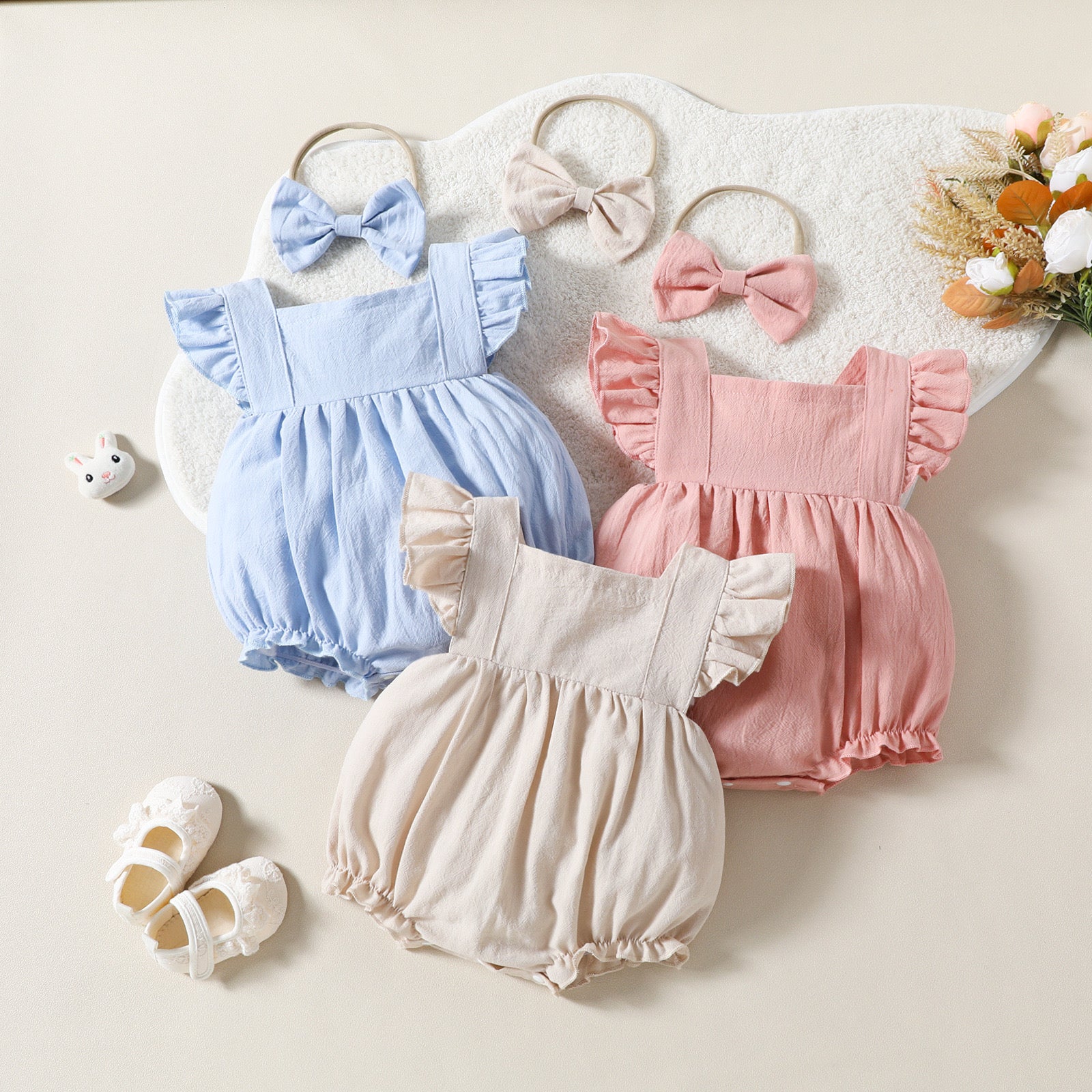Cute baby playsuit in beige.